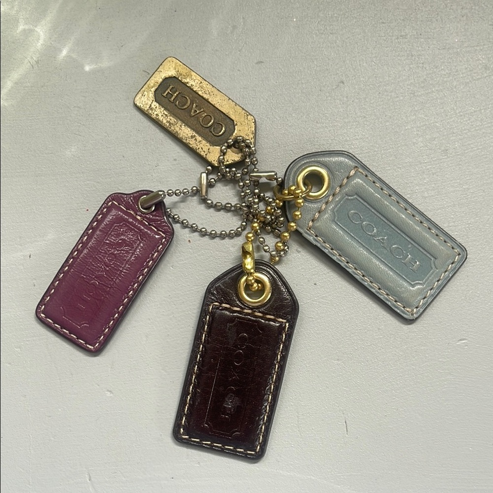 Coach Leather Tag Set in Purple, Brown, Blue, and Gold